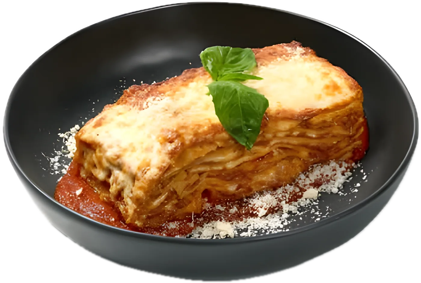 Classic Beef Lasagna on tomato sauce with grated parmesan and a basil leaf, in a black bowl