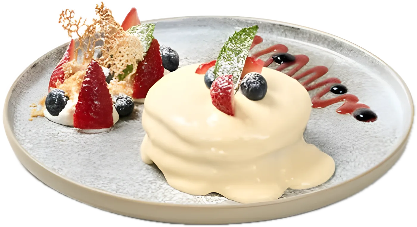 Custard & Berry Pancakes with berries, crème fraiche and blueberry compote on a grey plate